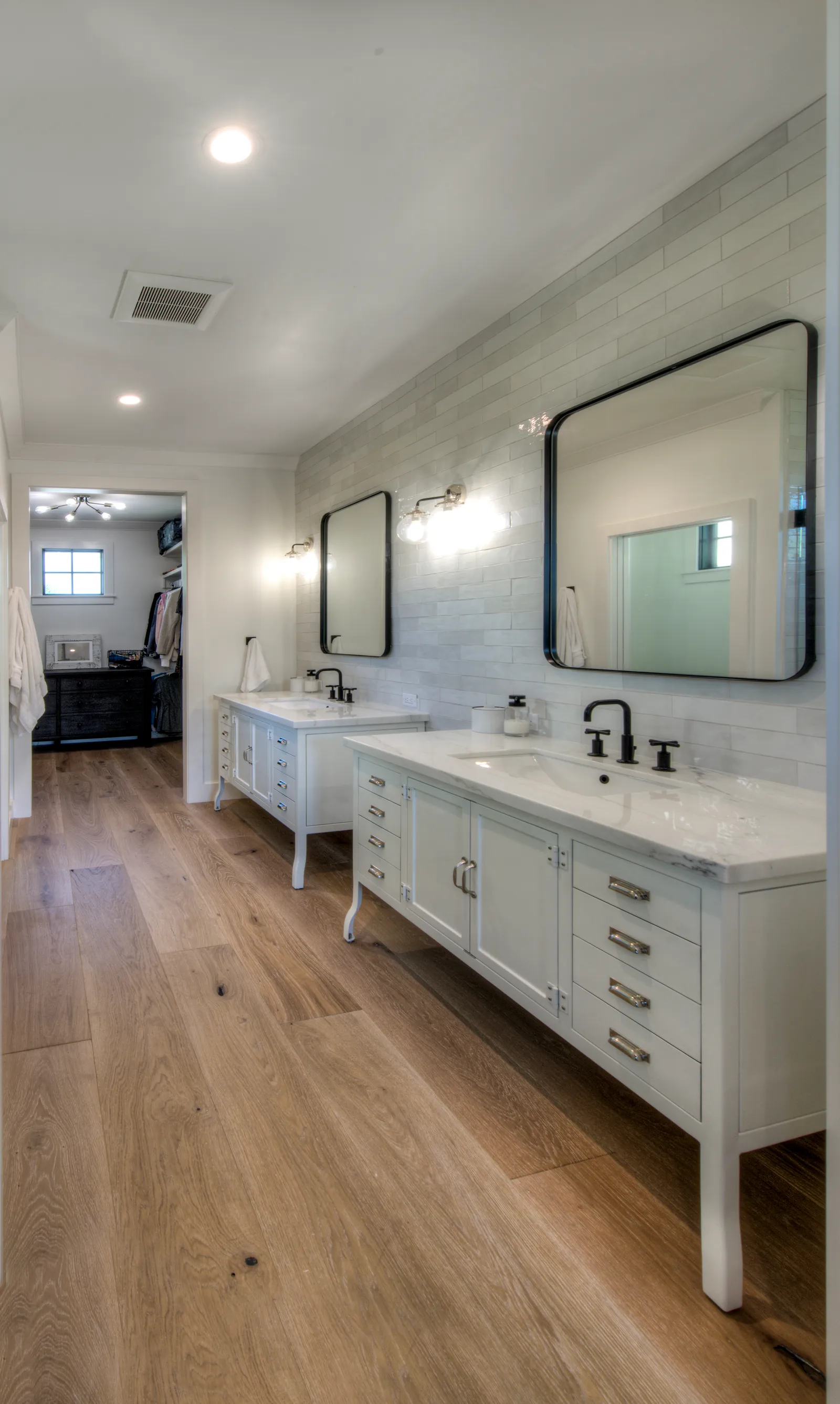 Bright primary bathroom with a white double vanity.