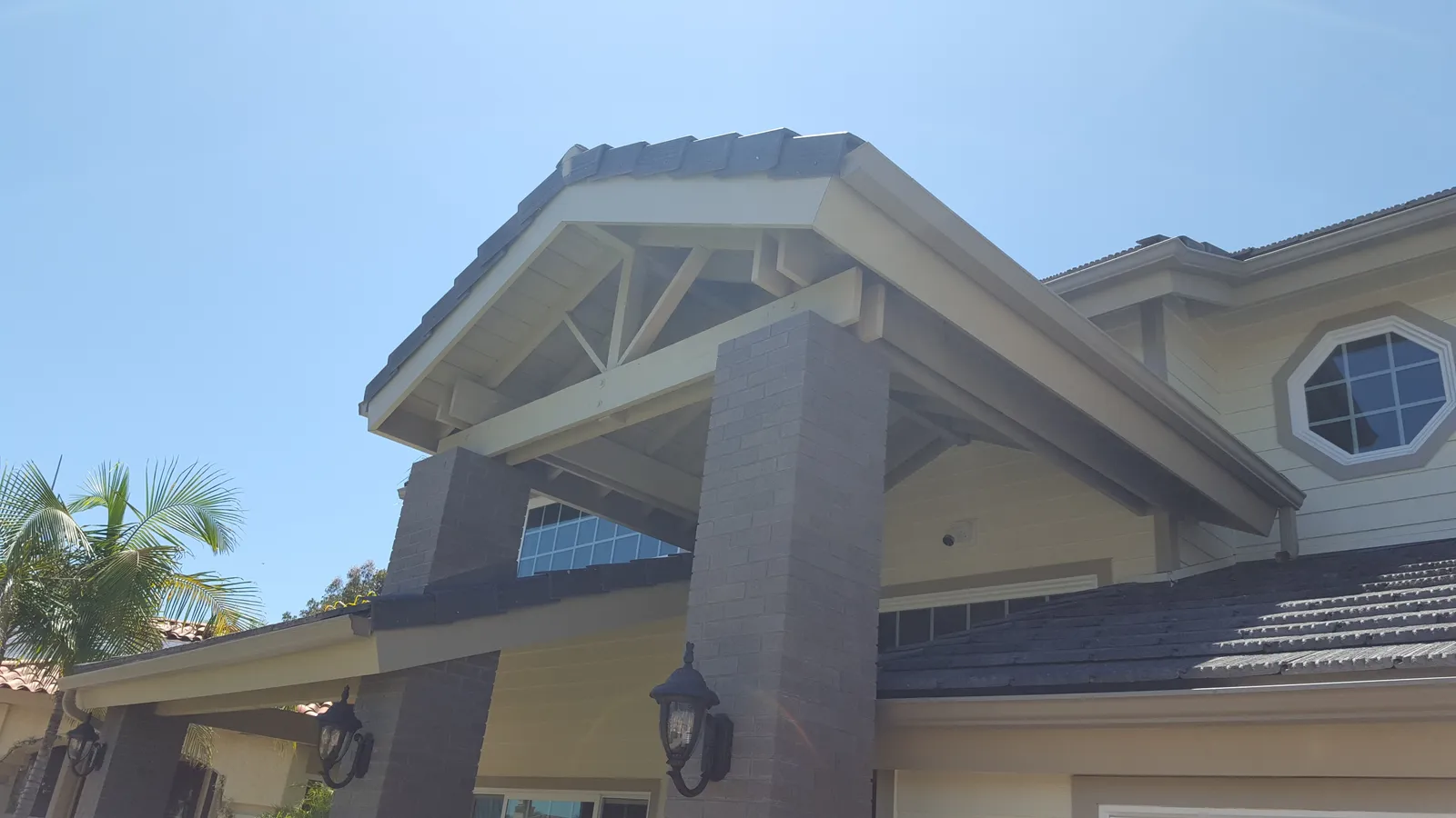 Modern home featuring white stucco, architectural wood elements, and contemporary design.
