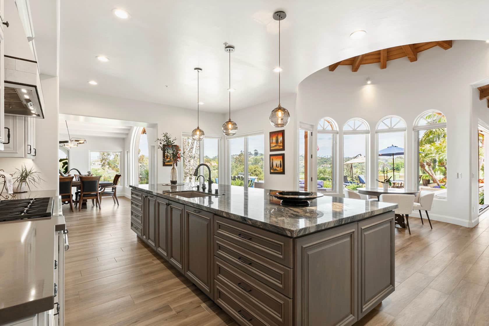 An elegant, light-filled remodeled kitchen and great room by Stel Builders in San Diego