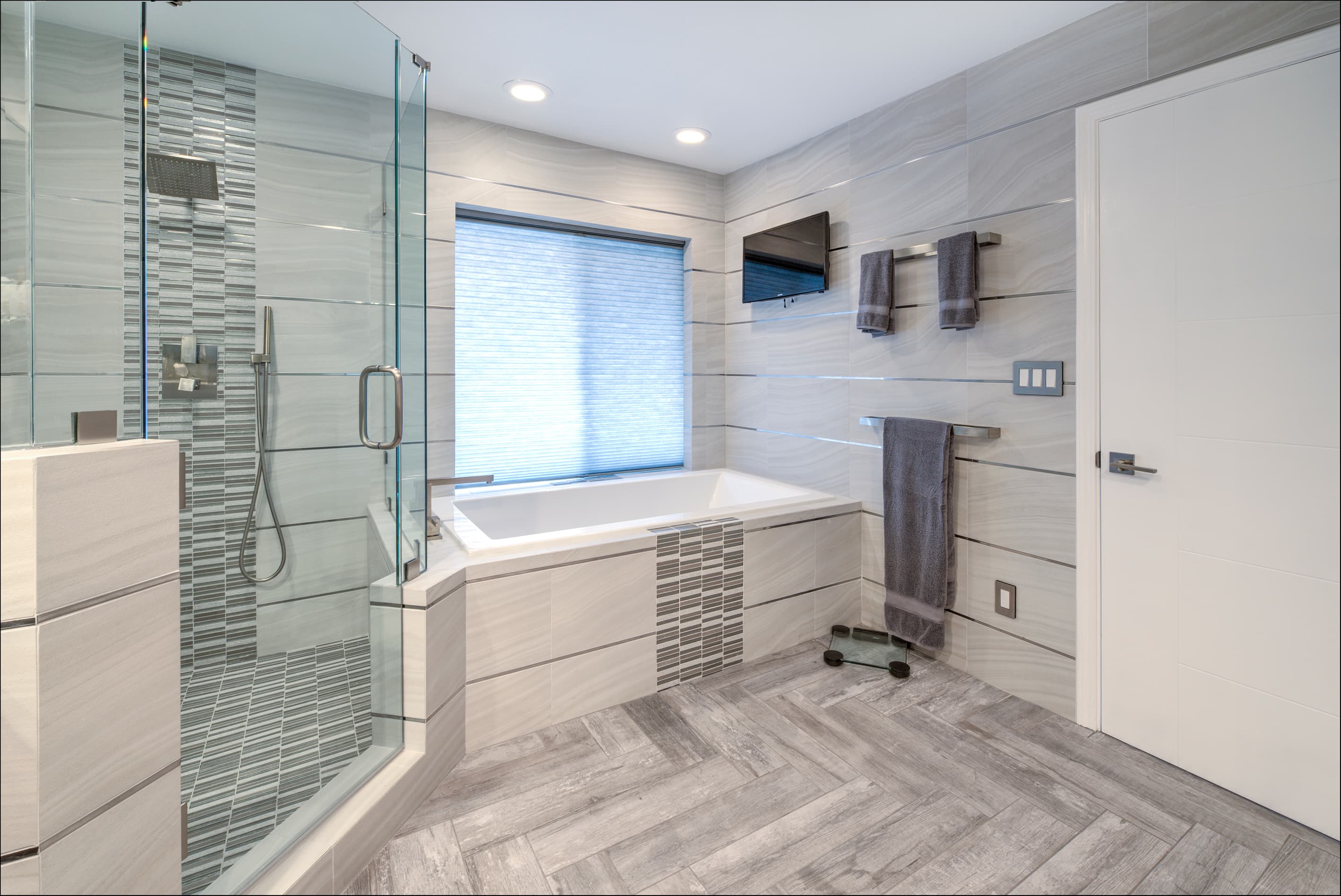 A contemporary remodeled bathroom with clean modern finishes.